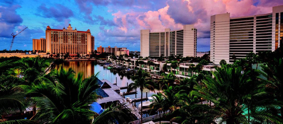 Densely packed waterfront residential area in Florida with boat docks and lush palm trees.