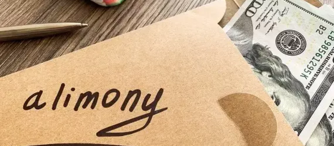 Brown envelope with money in it and the word alimony written on the envelope