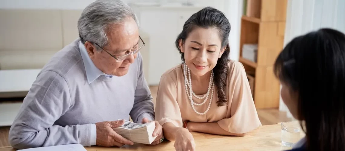 Older couple reviewing legal documents with attorney
